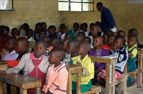 Students sit in rows at a Kenyan school.