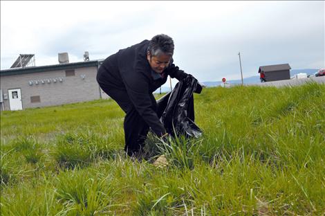 JoAnn Ducharme helps pick up litter during Ronan Cleanup Day. 