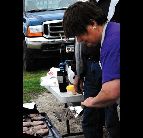 Beth Blevins cooks hamburger patties for visiting students.