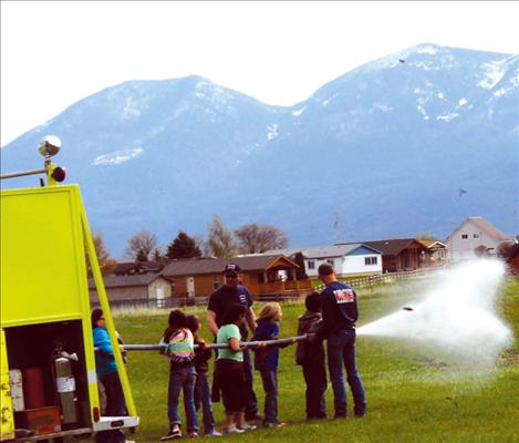 Students hang on tight to the fire hose.