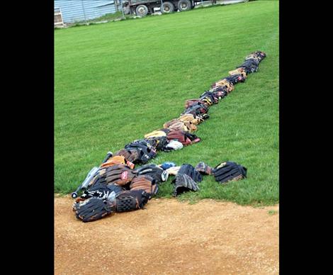 A line of small gloves and mitts await play.