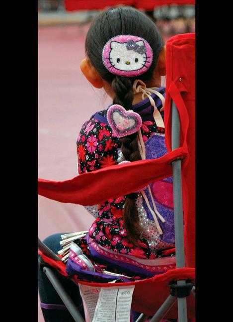 A young powwow dancer wears beaded Hello Kitty barrettes.