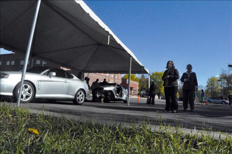 The family and legal counsel of two teenagers killed in a 2011 Arlee wreck view what is left of a Hyundai Tiburon. The crashed car was parked next to an undamaged version of the same vehicle as a visual aid for the jury. 