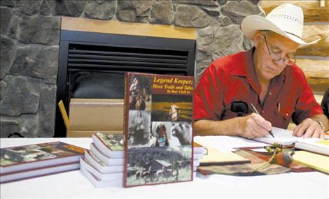 Bud Cheff Jr. signs a copy of his book for a fan. Cheff sold 120 books over the course of a few short hours during the signing.