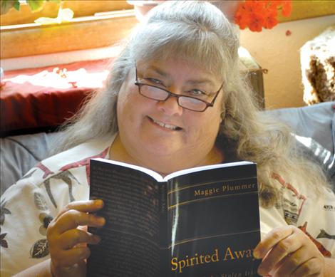 Maggie Plummer reads a proof copy of her novel, “Spirited Away.” The book is set in the 1700s, mostly in Barbados, and the main character is Freddie O’Brennan. Plummer will be holding local book signings.
