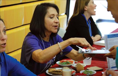 Janice Tate, left, and Pam Lockwood from Community Medical Center talk to people about diabetes and nutrition. 