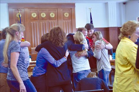 Family members of Trevor Olson and Tanner Olson embrace after a jury rules that a defective steering knuckle was the cause of a July 2, 2011 wreck that killed the teenagers. 