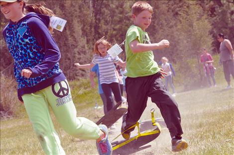 Trevor Sharbono runs through an obstacle course with classmates. 