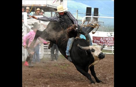 A bull rider tries to make the whistle during the Spur the Cancer out of Montana Rough Stock Rodeo held on Saturday.