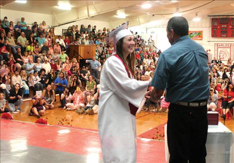 School board member Tom Haynes hands out diplomas to graduates.