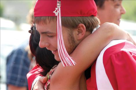 Austin Timmin gets a big hug at graduation.