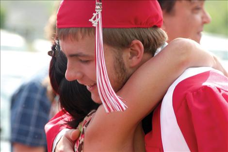 Austin Timmin gets a big hug at graduation.  