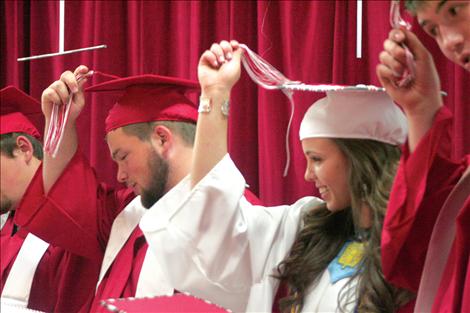 Arlee graduates move their tassels in a sign of accomplishment.