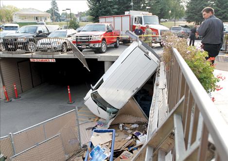 Emergency crews work to clean up the mess after a van crashed through a railing at the KwaTaqNuk Resort. No one was hurt in the accident.