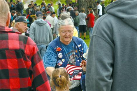 Letha Morgan helps distribute American flags in Ronan.