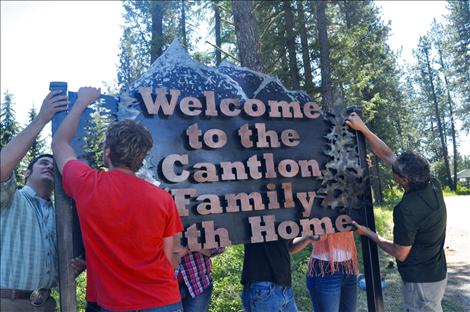 The Cantlon Family Youth Home receives a new sign made by vocational-ag students at Ronan High School. 