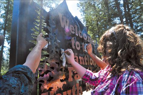 Megan Strickland/Valley Journal Ronan senior Cheyanne Smith polishes a sign made by the Ronan vo-ag class for the Cantlon Family Youth Home.  