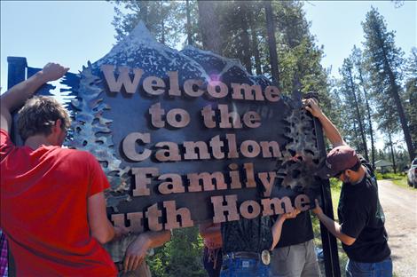 The Cantlon Family Youth Home receives a new sign made by vocational-ag students at Ronan High School. 