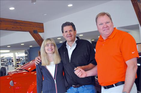 Debbie and Jim Pierce hand over the keys of their Ronan auto dealership, to nephew Tony Pierce. 
