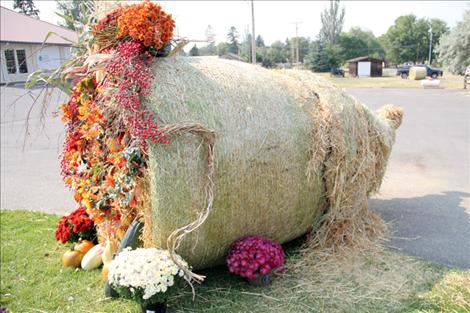 Round bale decorating competition entries like this cornucopia from Ronan Flower Mill/Home On The Range Pies are scattered throughout town. 