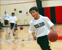 Duncan interacts with kids at hoop camp