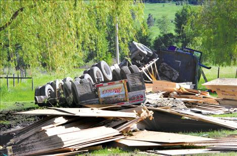 A load of Plum Creek lumber was scattered after the rig hauling it ended on its side off Highway 93 near Dayton June 3.