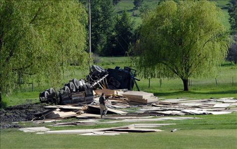 A load of Plum Creek lumber was scattered after the rig hauling it ended on its side off Highway 93 near Dayton June 3.
