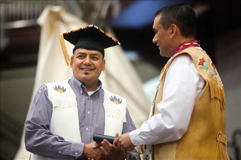 A graduate receives his diploma from SKC President Robert DePoe III.