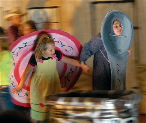 Alyssa Orien, the dish, left, and Adeline Warneke, the spoon, ran away as the cow jumped over the moon in the Valley View School play.