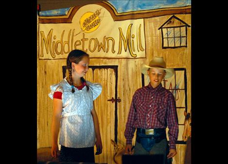 Mason Sloan, right, portrays Pecos Billl as he and a townsperson discuss the rhyming water. 