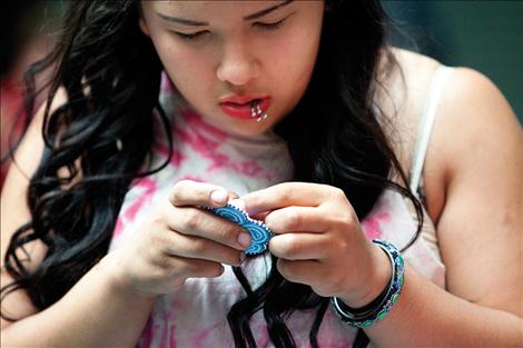 Two Eagle River student Kaci Ducharme puts the finishing touches on a beading project. 