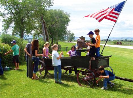 Charlo Junior Stockgrowers 4-H Club added linseed oil to wagons and benches at the Ninepipes Museum June 7. 