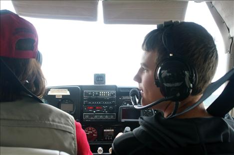 Levi Schmidt, 13, flies a Cessna airplane with the help of pilot Carmine Mowbray.