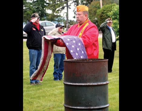 John Miller of the American Legion and Marine Corps League goes through the proper steps to retire a flag. 