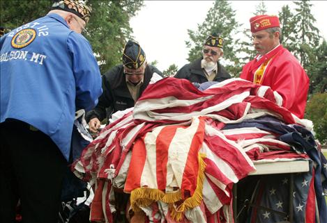 A pile of flags lie ready to be retired.  