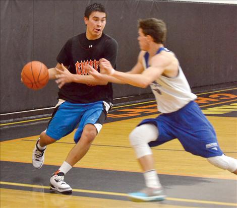 Players on the 5-on-5 teams fought in half-court games throughout the event, including Ronan’s Cedric Earthboy, shown battling a Bigfork player