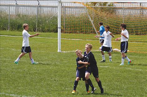 Nico River and Mack Moderie congratulate each other after  combining for the winning goal in the semifinal game.