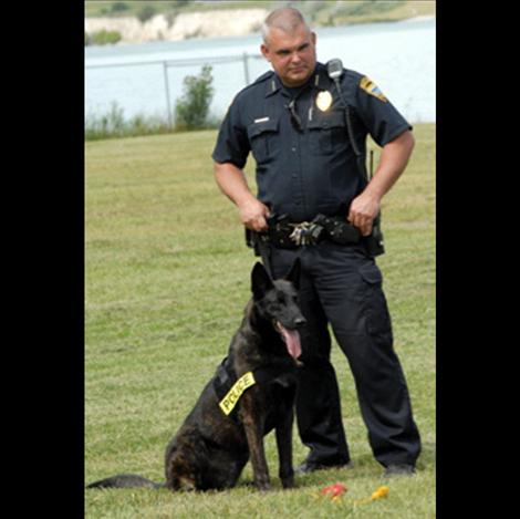 Berl Tiskus/Valley Journal Polson Police Chief Wade Nash stands with Llop as Officer Maso hides contraband for the dog to find.