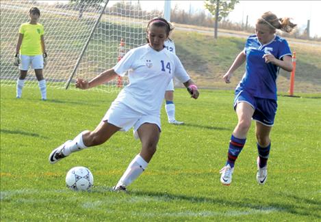 Lady Pirate Monica Cleveland boots the ball away from Polson’s goal. Cleveland usually plays keeper, but the keeper’s glove wouldn’t fit over her injured thumb.    