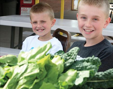 Tucker Brown, 9 and Tyler Brown, 11, sold donated turnips, beats, kale and carrots to help raise money for the Arlee Community Development Corporation.