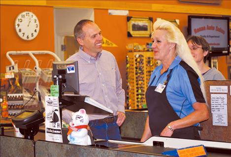 Greg Hertz of Moody Markets talks with employees of Super One Foods in Polson. The store stocks local produce and products.