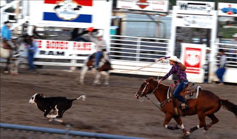 A breakaway roper pursues a speedy calf at the Friday night performance of the Mission Mountain NRA Rodeo. 