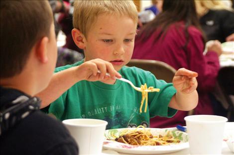 Bridger Adams, 5, attends a spaghetti fundraiser to support his friend Tyler Conover.