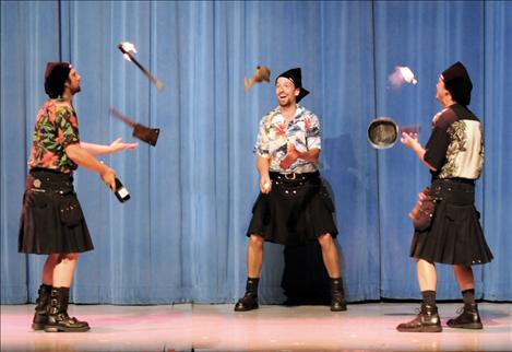 Members of The New Old Time Chautauqua juggle crazy objects, some lit by fire.