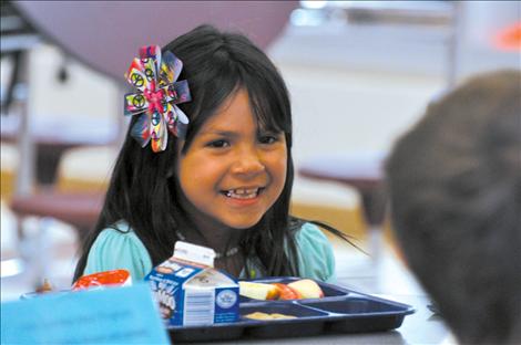 De-Ja-Nay Littlemarry smiles over school lunch.