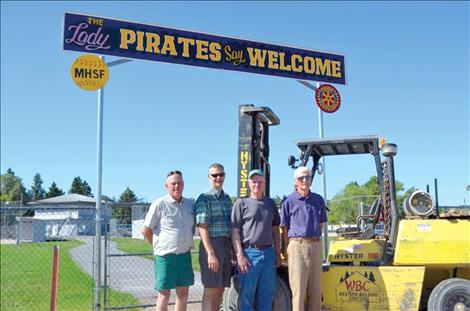 Tom Fieber, left, a member of the Polson Softball Association who spearheaded the fundraising, is joined by Dave Ottun, Dave Templeton and Larry Smith at the new entrance to the Polson softball fields.