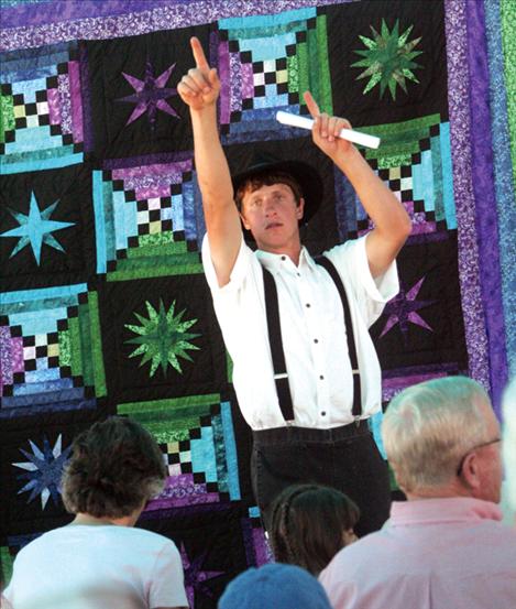 Jason Miller catches bids during the quilt auction.