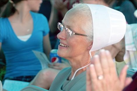 Lorene Yoder watches in amazement as the quilt she made went  for $1,150  at the auction.