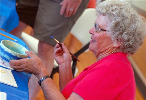 Agnes Rinehart paints a bowl as one of the fundraisers at the MVAC.