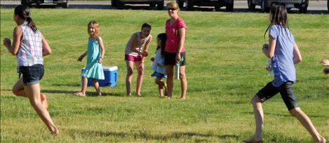 Kids enjoy a water fight on the lawn during the Mission Valley Aquatic Center’s 1st Anniversary Celebration.